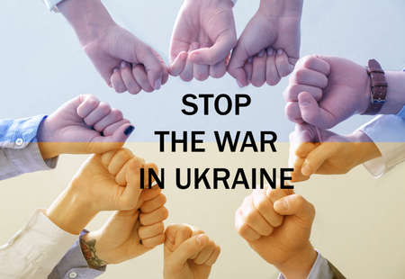 People holding clenched fists together and text STOP THE WAR IN UKRAINEの写真素材