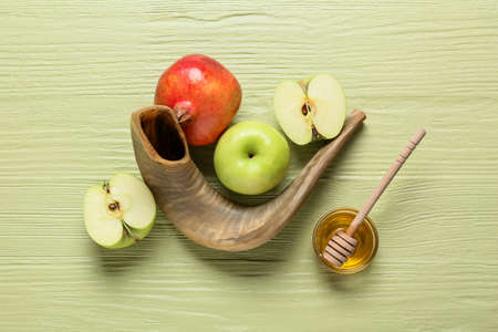 Honey with fruits and shofar on color wooden background. Rosh hashanah (Jewish New Year) celebrationの写真素材