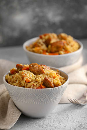 Bowl with tasty Asian pilaf on tableの写真素材