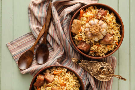 Bowls with tasty Asian pilaf on tableの写真素材