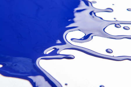 Blotches of blue paint on white background, closeup