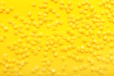 Heap of sprinkles on yellow background