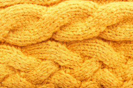 Texture of yellow knitted clothes, closeup