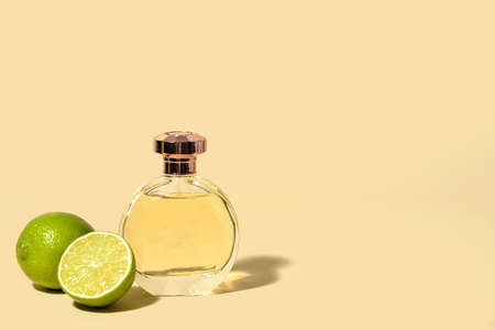 Bottle of citrus perfume on light color backgroundの写真素材