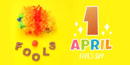 Greeting card for April Fool's Day with clown wig and nose on yellow backgroundの写真素材