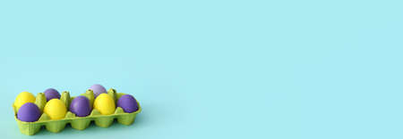Holder with painted Easter eggs on light blue background with space for text