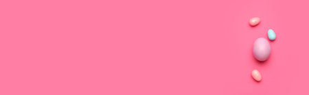 Painted Easter eggs on pink background with space for text