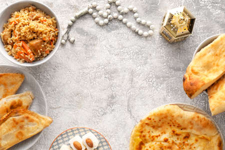 Frame made of traditional Eastern dishes with tasbih and fanoos lamp on grunge backgroundの写真素材