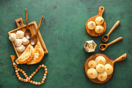 Traditional Eastern dishes with tasbih and fanoos lamp on color backgroundの写真素材