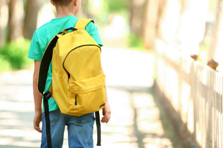 Little schoolboy with backpack outdoorsの写真素材