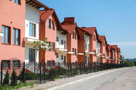View of modern town cottages on sunny dayの写真素材