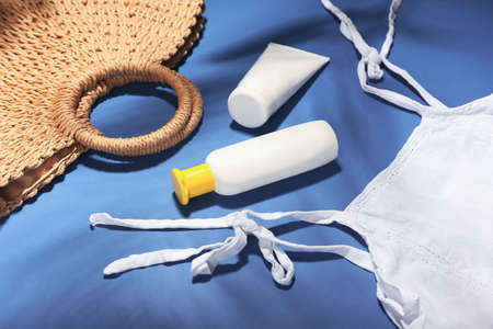 Set of beach accessories on color background