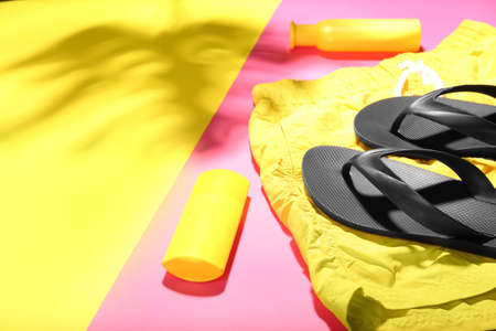 Set of beach accessories and cosmetics on color background