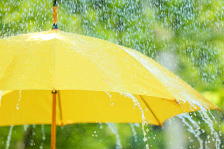 open umbrella under falling rain drops outdoorsの写真素材