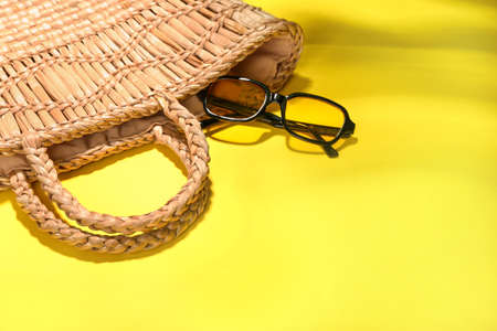 Stylish sunglasses and bag on color backgroundの写真素材