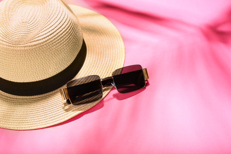 Stylish sunglasses and hat on color backgroundの写真素材