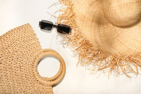 Stylish hat, bag and sunglasses on light backgroundの写真素材