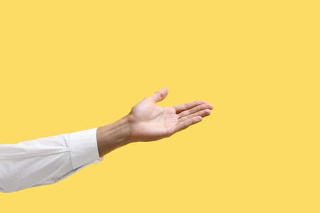 young male hand on color background