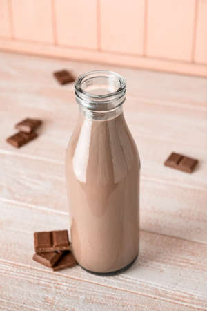 Bottle of delicious chocolate milk on wooden backgroundの写真素材