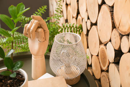 Wooden hand and decor on the table in the room