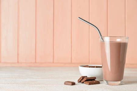 Glass of delicious chocolate milk on wooden backgroundの写真素材