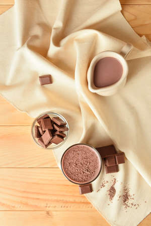 Delicious chocolate milk on wooden background