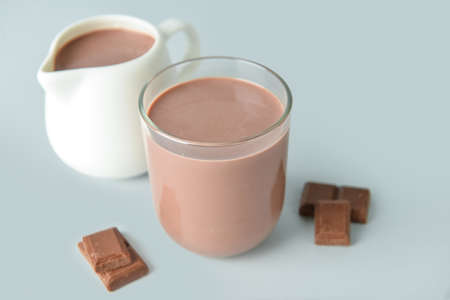 Delicious chocolate milk on gray background