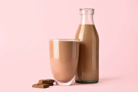 Delicious chocolate milk on color background