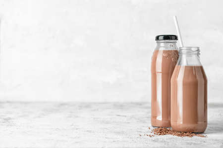 Bottles of delicious chocolate milk on grunge backgroundの写真素材