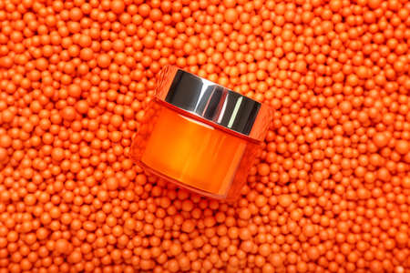 Cream in cosmetic jar on color backgroundの写真素材