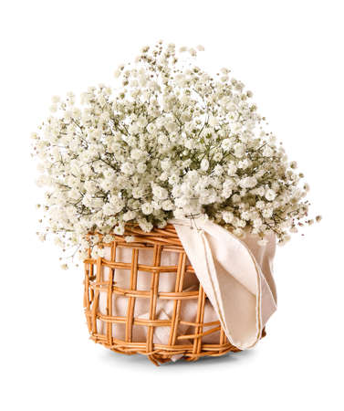 Wicker basket with beautiful flowers on white backgroundの写真素材