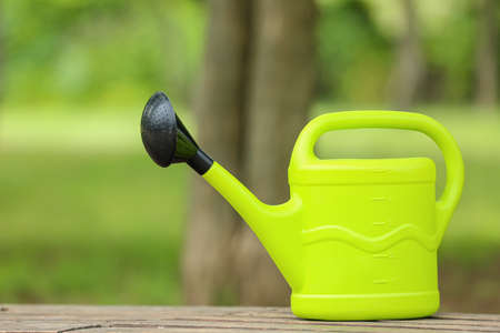 Watering can on bench in park