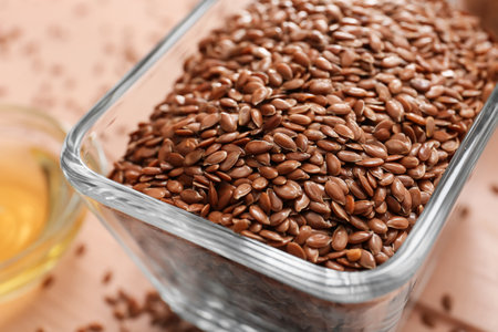 Bowl with flax seeds on table, closeupの写真素材
