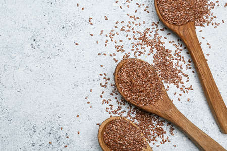 Spoons with flax seeds on light backgroundの写真素材