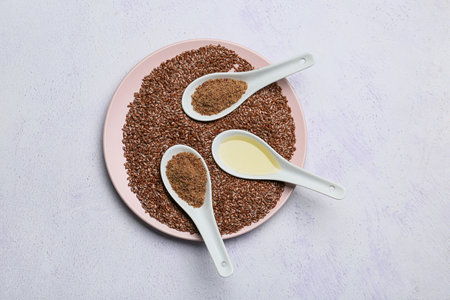 Plate with flax seeds and oil on light backgroundの写真素材
