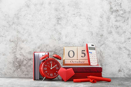 Cube calendar with alarm clock and stationery on grunge backgroundの写真素材