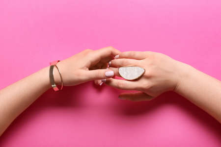 Woman with beautiful manicure and stylish jewelry on color backgroundの写真素材
