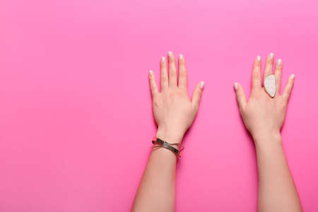 Woman with beautiful manicure and stylish jewelry on color backgroundの写真素材