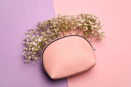 Bag with beautiful gypsophila flowers on color backgroundの写真素材