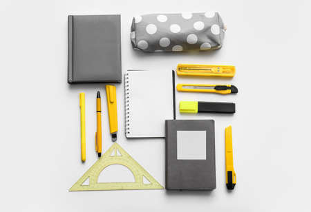 Pencil case and stationery on white background