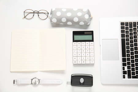 Composition with pencil case, female accessories and laptop on white background, closeupの写真素材