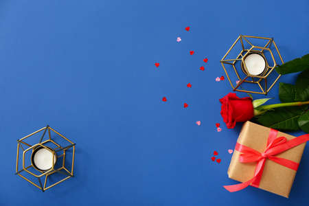 Valentine's Day gift, rose and candles on color backgroundの写真素材