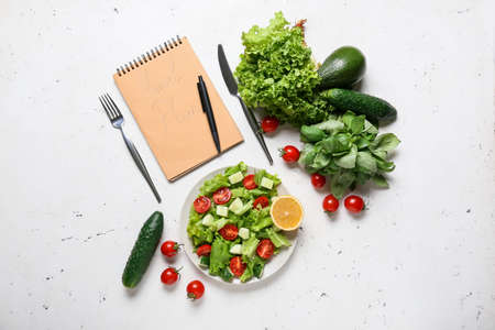 Composition with meal plan and healthy products on light backgroundの写真素材