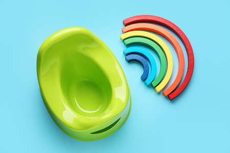Potty and wooden rainbow on color backgroundの写真素材