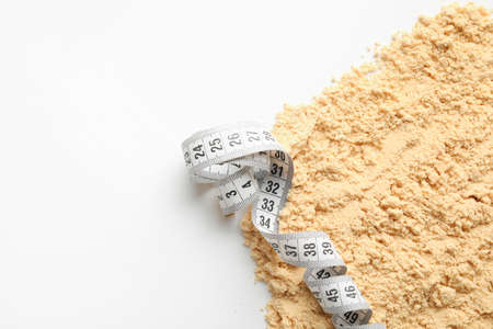 Protein powder and measuring tape on white background, closeupの写真素材