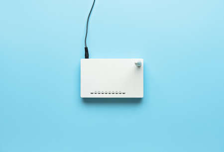 Wi-Fi router with antenna and network cable on color backgroundの写真素材