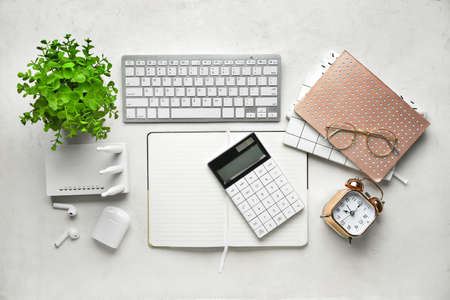 Wi-Fi router, keyboard and stationery on light backgroundの写真素材