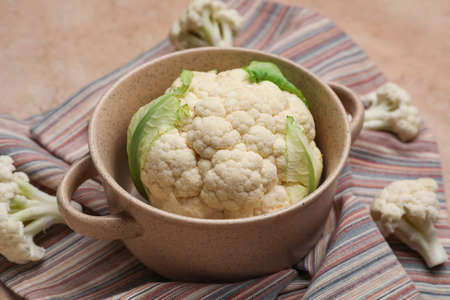 Pot with cauliflower cabbage on color background, closeupの写真素材
