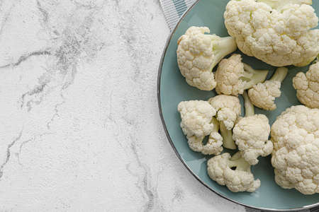 Plate with cauliflower cabbage on light backgroundの写真素材