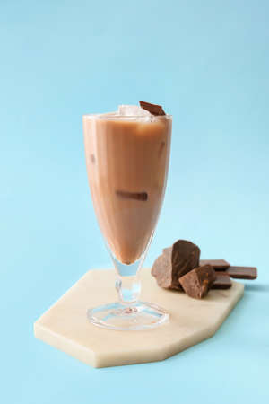 Glass of tasty chocolate milk on color backgroundの写真素材